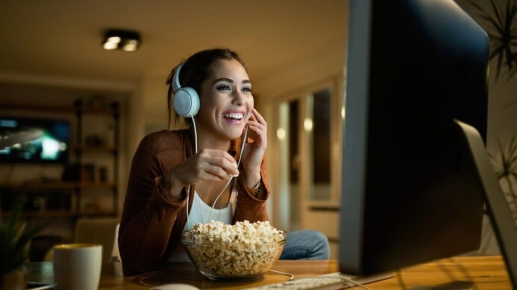 image depicts that this girl is watching movie or show on OTT